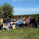 L'artista Ravel e i ragazzi della fattoria sociale Rurabilandia posano insieme alla scultura di pesce spada SPA-DINO realizzata con materiali di recupero.